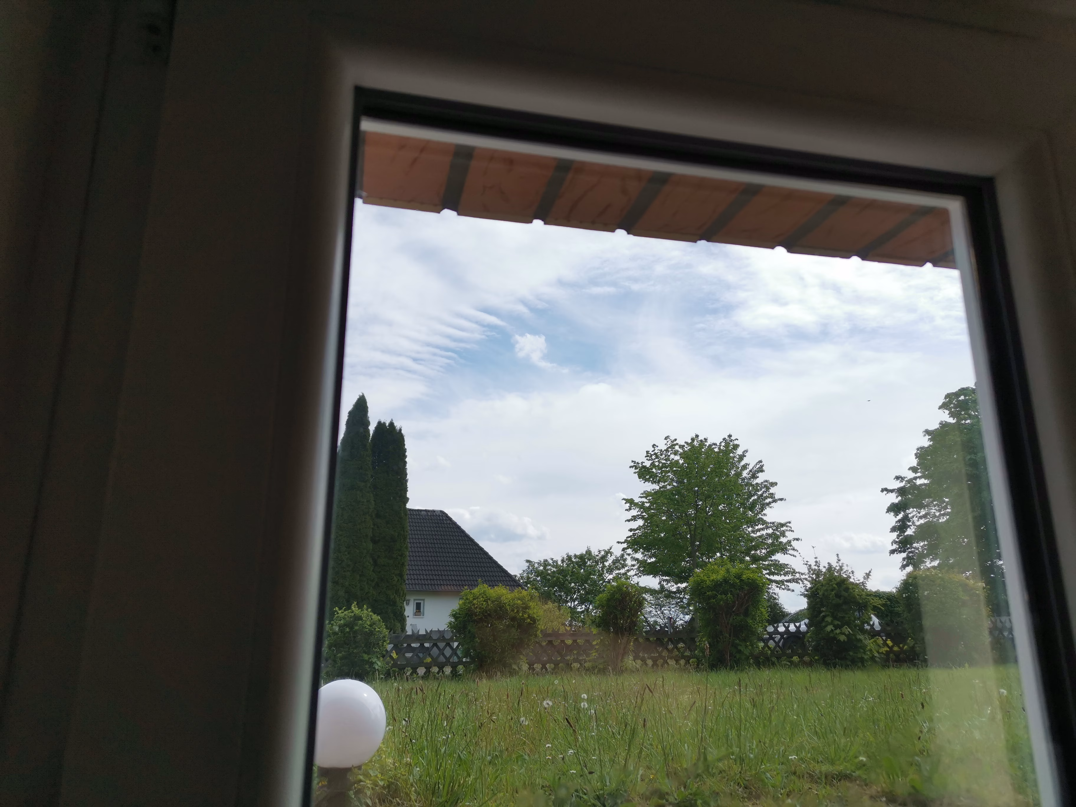Silber verspiegelte Spionspiegelfolie als Sichtschutz an einem Fenster.