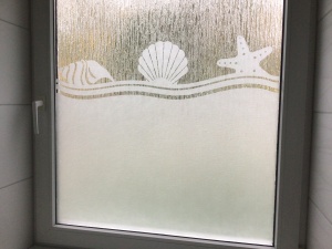 Fensterfolie mit Strand und Muschel